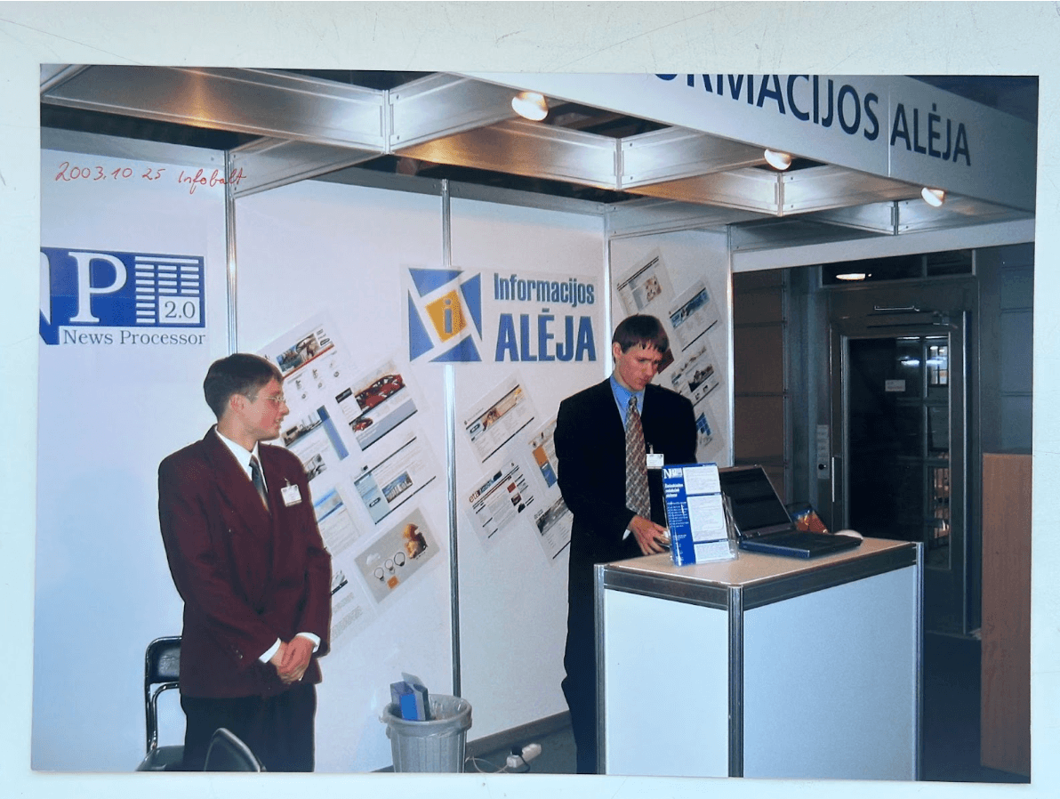 people at a conference in a booth