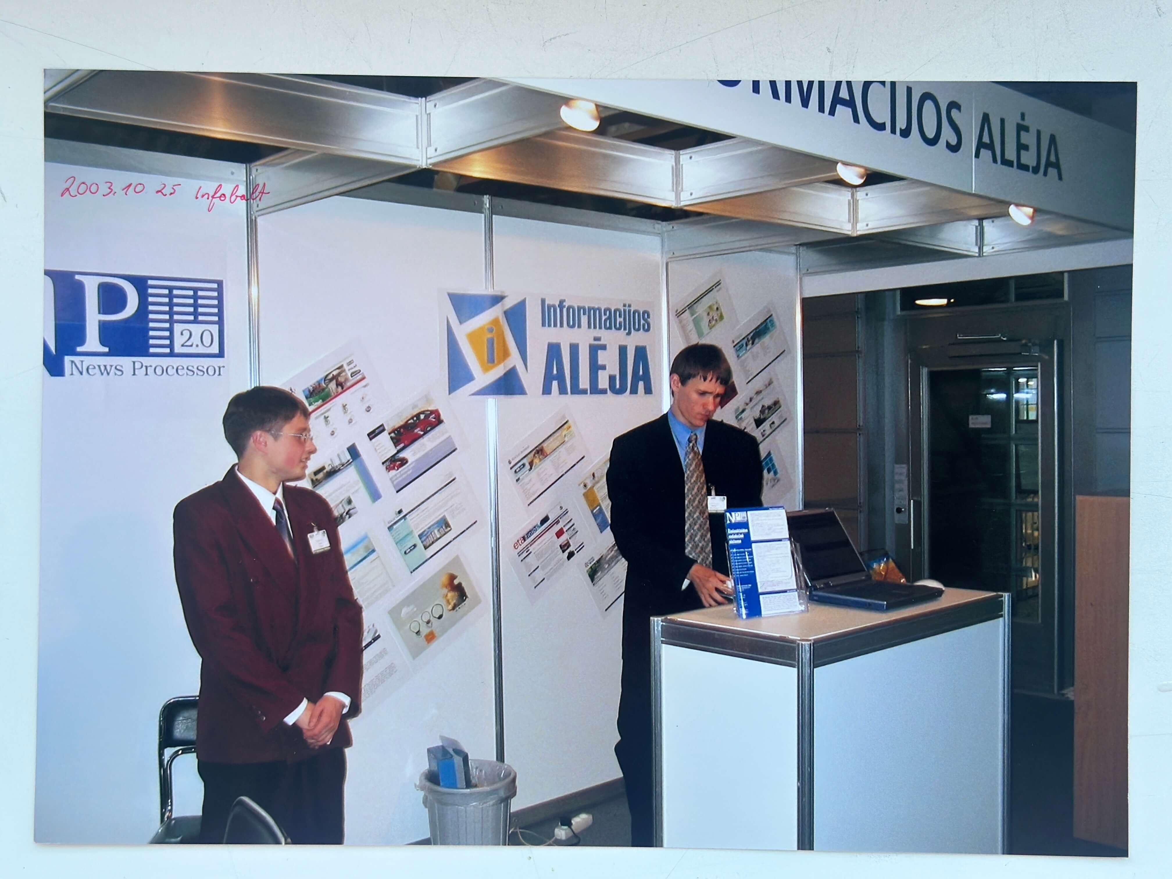 people at a conference in a booth